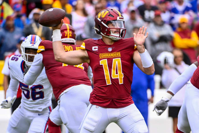 Washington Commanders quarterback Sam Howell (14)j attempts a pass against the Buffalo Bills during the first half at FedExField.